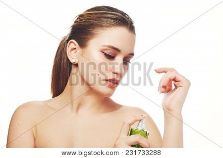 Half Nude Female With Pony Tail, Has Professional Make Up, Healthy Pure Skin, Uses Parfume For Pleas
