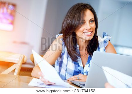 Woman with papers in their living room