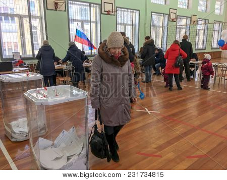 Moscow, Russia - March 18, 2018: The Voter Puts The Ballot In The Box In The Elections  Of President
