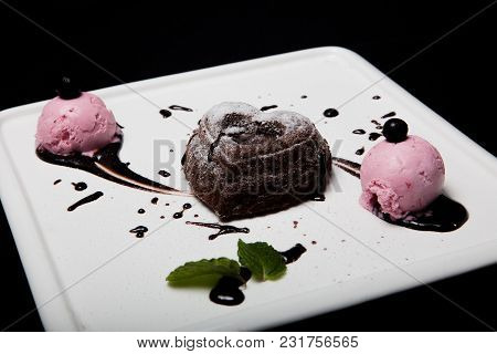 Dessert Fondan Chocolate With Ice-cream On A White Plate On A Black Background. Exquisite French Cho