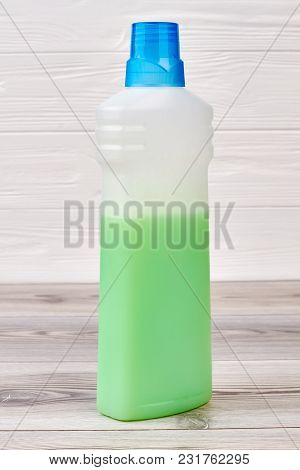 Plastic Bottle Of Rinser For Washing Clothes. Used Softener For Washing On Wooden Background. Condit