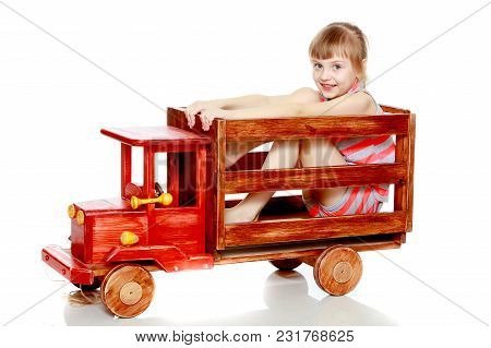 Beautiful Little Caucasian Girl With A Short Bangs And Hair Tucked Into A Tail. In Striped In A T-sh