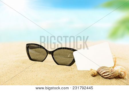 Vacation Concept Image - Sunglasses, Shells And Blank White Card On A Sandy Tropical Beach In Close-