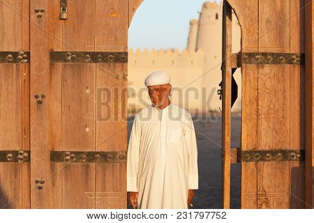 Al Ain, Uae - November 18, 2005: An Unidentified Caretaker At The Entrance To The Iconic Al Jahli Fo