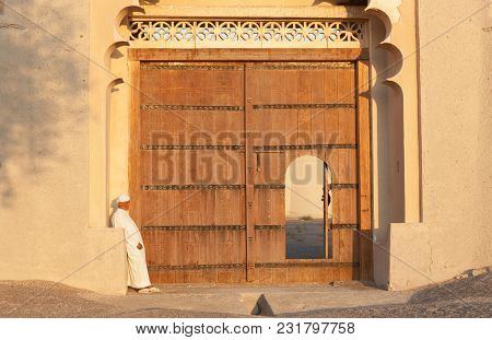 Al Ain, Uae - November 18, 2005: An Unidentified Caretaker At The Entrance To The Iconic Al Jahli Fo