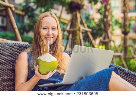 Young Female Freelancer Sitting Near The Pool With Her Laptop. Busy At Holidays. Distant Work Concep