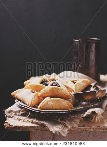 Hamantaschen Cookies With Poppy Seed And Risins And Icing Sugar On A Plate, Cooked For Jewish Festiv