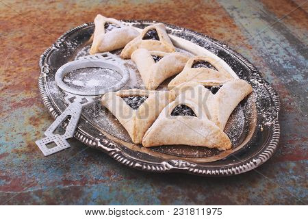 Hamantaschen Cookies With Poppy Seed And Risins And Icing Sugar On A Plate, Cooked For Jewish Festiv