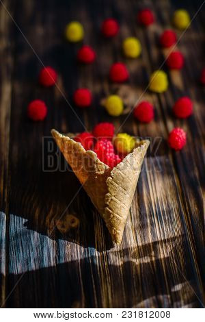 Waffle Cone With Berries On A Wooden Background.