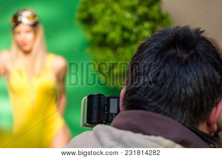 Fashion Shooting Scene In Studio. Rear View Of Photographer.