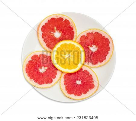 Top View Of The White Dish With Several Round Slices Of The Ripe Red Grapefruit And One Slice Of Ora