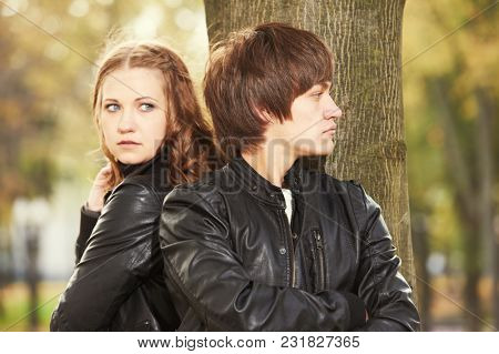 Relationship trouble or problem. Depressed woman and man in park