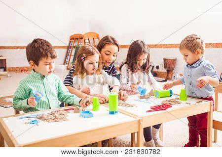 Teacher And Kids Play With Creative Kinetic Sand On The Table