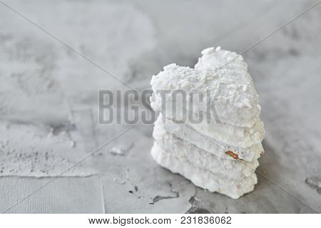 Sweet Crunchy Coconat Heart-shaped Biscuits Arranged In Pattern On Light Textured Background, Top Vi