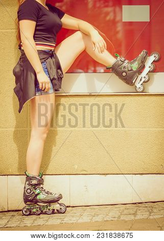 Woman Wearing Roller Skates In Town. Female Being Sporty During Summer Time.