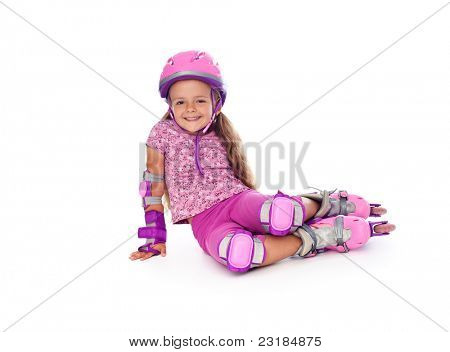 Happy little girl with roller skates and protective gear resting - isolated
