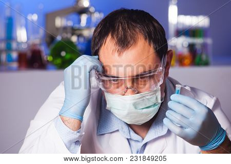 Scientist Is Thinking About Research And Hold Eppendorf Tube