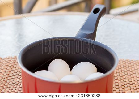A Few Boiled Eggs In A Saucepan On Table