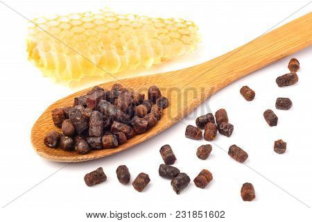 Granules Of Bee Bread In A Wooden Spoon Are Isolated On A White Background. Apitherapy. Beekeeping P