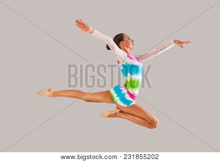 Young Slim Gymnast Jumps Sporty Figure Indroors