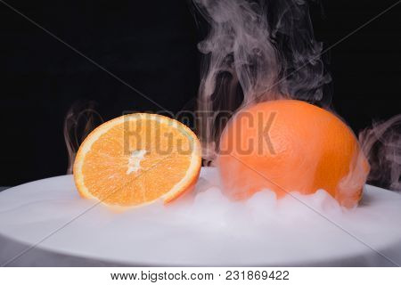 Fresh Frozen Fruit In Ice. Black Background