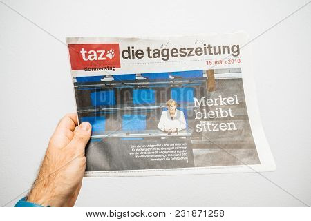 Paris, France - Mar 19, 2017: Man Reading German Die Tageszeitung Newspaper At Press Kiosk Featuring