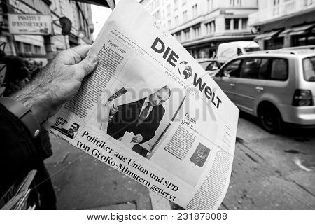 Paris, France - Mar 19, 2017: Man Reading Buying German Die Welt Newspaper At Press Kiosk Featuring 