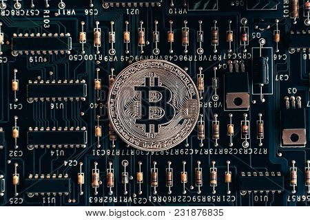 Printed Circuit Board With A Chip And Resistance And A Bitcoin. The Concept Of The Mining Of Crypto-
