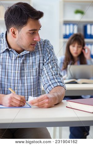 Students sitting and studying in classroom college