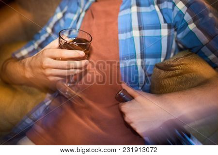 Close-up of man with wineglass and bottle