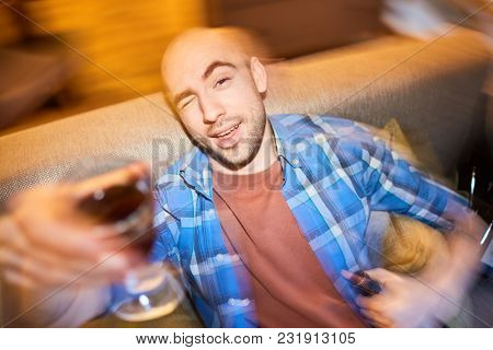 Young man drinking wine. Blurred motion of man with glass