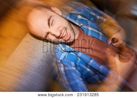 Man having fun at a party. He is drinking wine