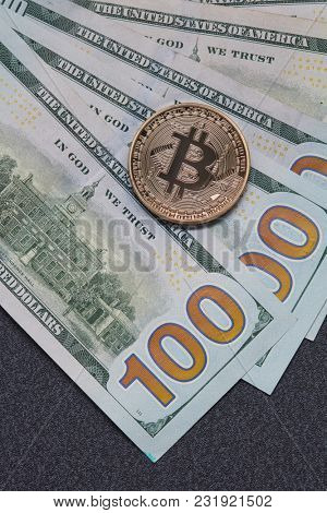 Gold coin bitcoin and new hundred dollar bills. Exchange of Crypto-Currency for Dollars