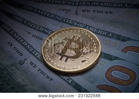 Golden bitcoin Cryptocurrency coin on a pile of US dollars, underground economy and cryptocurrency concept