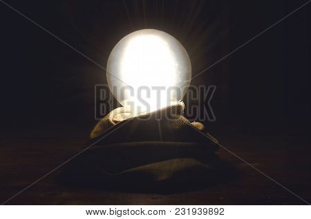 Crystal Ball On Fortune Teller Desk Table Background. Seance Concept. Future Reading.