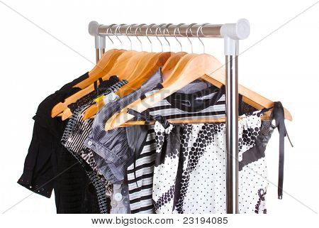 เสื้อผ้าต่าง ๆ บนไม้ hangers แยกต่างหากบนพื้นสีขาว