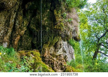 Photo Of Little Beautiful Waterfall Flowing In Cave