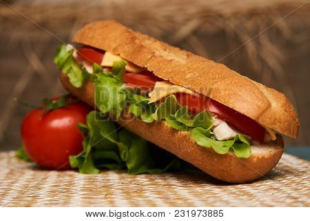 Fresh Submarine Sandwich With Chicken Fillet, Cheese, Fresh Tomatoes, Lettuce, Cucumbers And Onions 