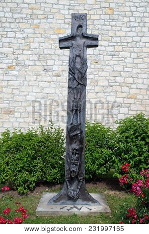 LEUTERSHAUSEN, GERMANY - JULY 05: Cross by Sieger Koeder in front the Church of Saint Bartholomew in Leutershausen, Germany on July 05, 2017.