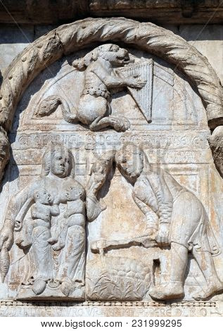 VERONA, ITALY - MAY 27: Bas-relief of Maestro Nicolo' (12th century), group to the right of the door of the Basilica of St Zeno, UNESCO World Heritage Site, in Verona, Italy, on May 27, 2017.