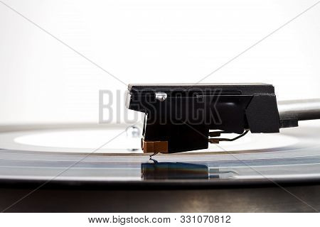 Close Up Of Turntable Needle On A Vinyl Record Turntable Playing Vinyl Needle On Rotating Black Vinyl Poster Id