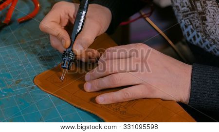 Professional Male Skinner, Tanner Making Decorative Details On Leather Playing Field For Strategy Bo