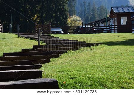 lots of steps in the middle of a meadow in  a sunny autumn day