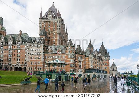 Quebec City, Canada - August 6, 2015:people Stroll On The Dufferin Terrace With The Famouse Frontena