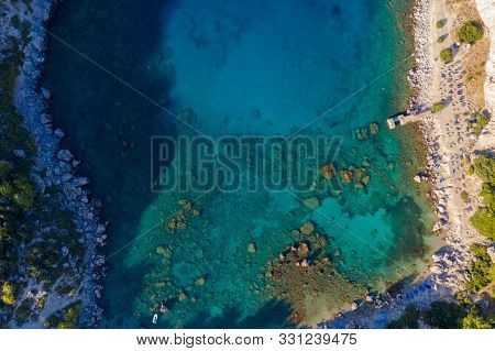 Aerial Birds Eye View Photo Taken By Drone Of Famous Beach Of Anthony Quinn With Clear Water Rocky S