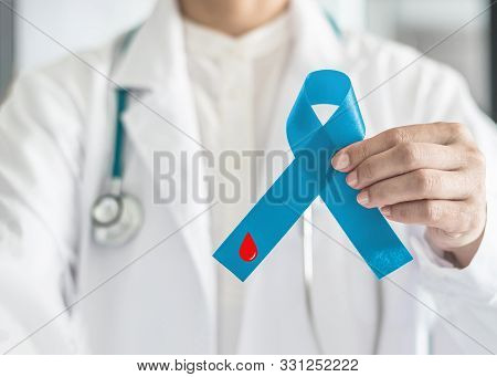 Diabetes Awareness Ribbon For World Diabetes Day With Red Blood Drop On Blue Bow Color In Doctor Han