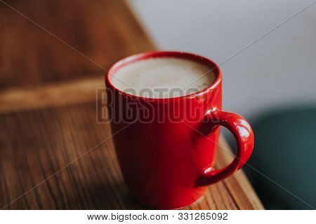 Red Cup With Mokachino Coffee In A Cafe On A Dark Background
