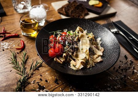 Black Angus pappardelle pasta with beef, champignon and parmegano cheese