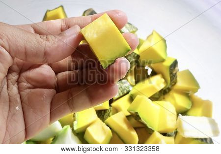 Vegetable, Hand Holding Raw Chopped Angled Gourds Or Sponge Gourds With Pumpkins And Baby Corns Prep