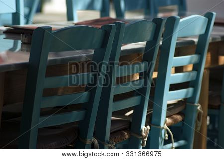 Empty Taverna Tables And Seating At A Restaurant In A Square On The Island Of Folegandros. Close Up 